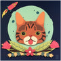 An orange and brown striped cartoon cat sits in a collage-like scene with a green moon backdrop. Meghan Stratmans The Cat From Outer Space includes a red rocket in the top left, pink flowers below the face, all set against a dark, starry sky.