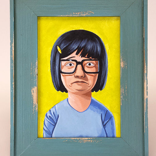 The Geoff Trapp framed painting A Portrait of Tina showcases a cartoon character from Bobs Burgers, wearing glasses and a blue shirt against a yellow background, with black hair featuring a yellow clip. The artwork is in distressed blue wood, echoing Spoke Art NYC exhibitions.