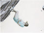 A person in a light, translucent dress seems to float gently against a minimalistic background. This sideways image evokes levitation next to a textured surface, resembling Henrik Aarrestad Uldalens style in this signed and numbered fine art giclee print by Henrik Uldalen.