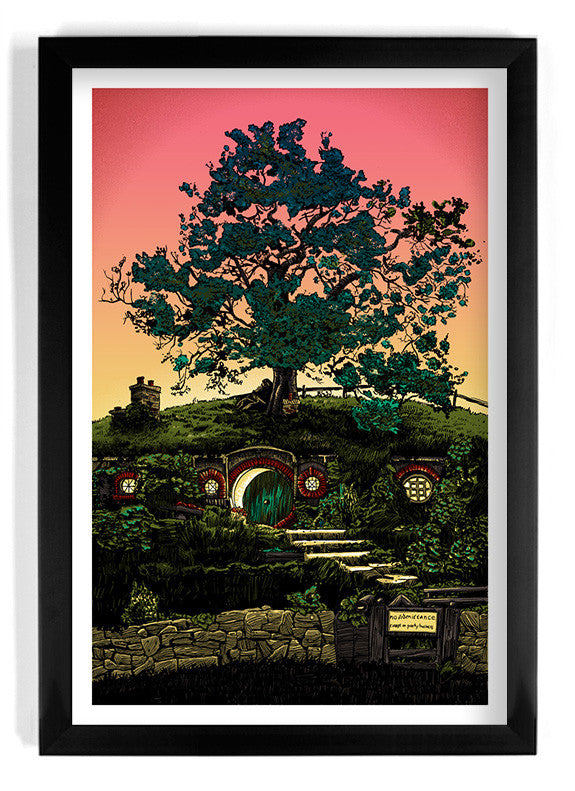 A framed screen print by Tim Doyle depicts a tree on a lush green hill with round doors and windows, resembling a hobbit home from Lord of the Rings. The skys pink and orange gradient casts a warm glow over the scene.