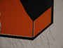 An up-close view of an abstract artwork showcases geometric shapes in black and orange with scribbled gray lines at the bottom, capturing the bold essence of Shark Toofs fine art prints in a modern, minimalist style.