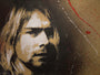 A stencil-style portrait reminiscent of Kurt Cobain with long hair and a serious expression, featuring a dramatic textured background splattered in red and white paint, showcasing Jef Aérosols signature monochromatic brilliance.