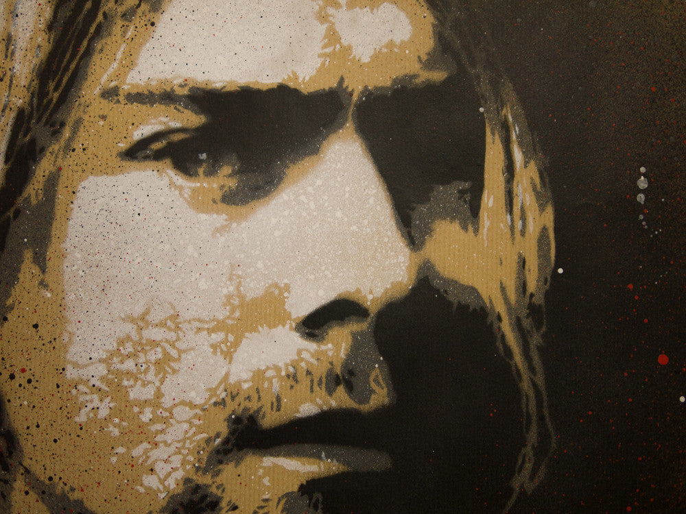 A stencil-style artwork by Jef Aérosol depicts a long-haired person with a thoughtful look, capturing Kurt Cobains enigmatic aura. It features a speckled texture in black, brown, and white shades.