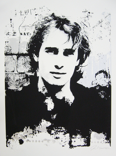 John Graysons limited edition screen print features a monochromatic portrait of a person with wavy hair against a textured background. High contrast black and white blend to create an abstract effect, evoking the ethereal aura associated with Jeff Buckley.