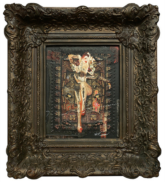 The ornate, antique frame by Handiedan showcases an intricate artwork depicting a surreal human figure with abstract patterns and textures. This mixed media collages dark palette contrasts beautifully with the detailed frame.