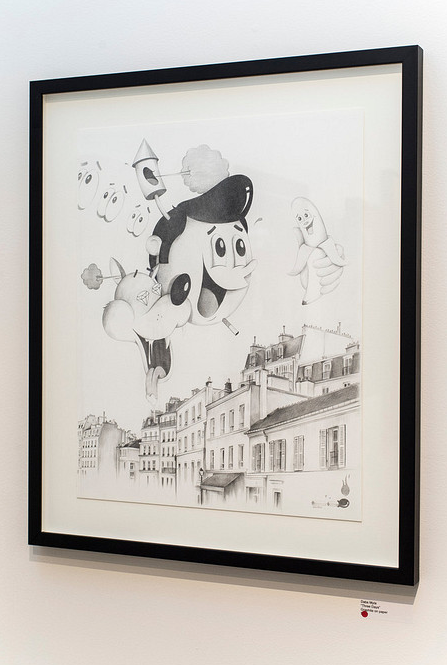 A Dabs Myla framed artwork showcases cartoonish, surreal faces and shapes above a detailed graphite sketch of an old European-style cityscape. Displayed at Spoke Art Gallery, this piece artfully blends whimsical and realistic black-and-white elements.