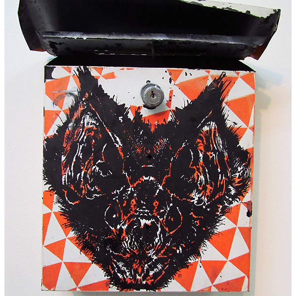 Euths wall-mounted enamel on metal mailbox, titled Untitled (bat), showcases a bold black bat with intricate details on its open lid. The background features an eye-catching geometric pattern of orange and white triangles.