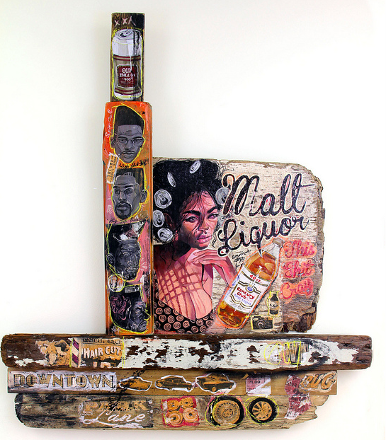 This mixed media artwork by Serge Gay Jr. features an acrylic painting of a woman with curlers holding a Malt Liquor bottle, surrounded by smaller portraits and urban-themed text and images, creating a vibrant display on wooden planks.