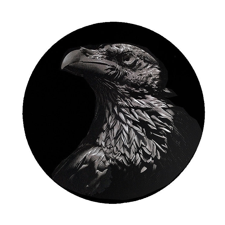Tracie Chings artwork depicts a detailed eagle head in profile on a black circular background. Intricate lines evoke the mystique of George R.R. Martins Three-eyed Raven, emphasizing feather texture and commanding presence within its custom frame.