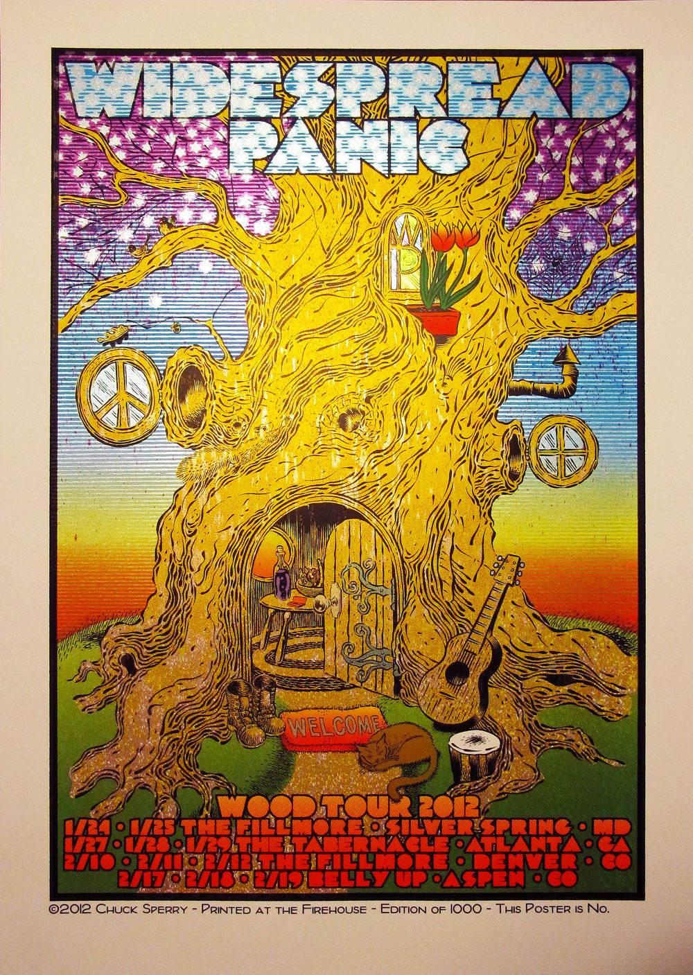Colorful concert poster by Chuck Sperry for Widespread Panics 2012 tour features a large tree with peace signs, a guitar, flowers, and an open door. This vibrant retrospective print lists event locations and dates at the bottom.