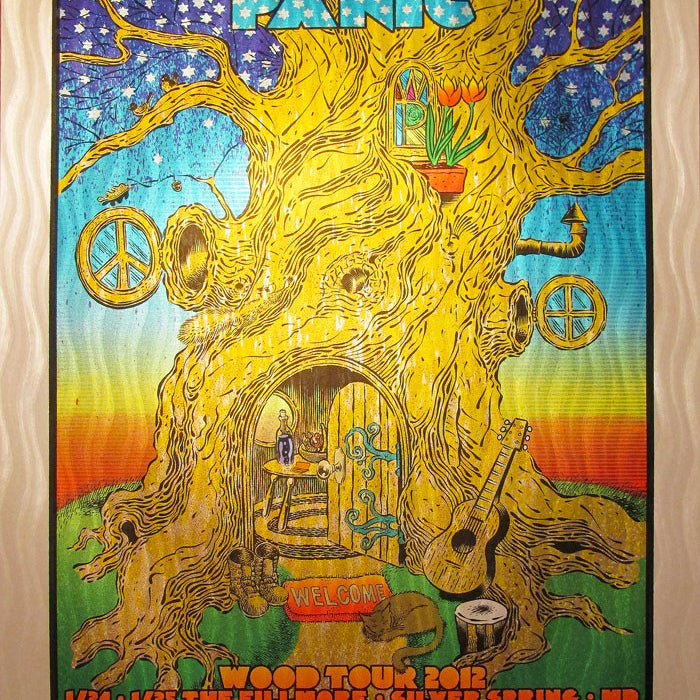 Vibrant Chuck Sperry poster for Widespread Panics Wood Tour 2012 showcases a whimsical treehouse with musical elements like a guitar and swirling wave foil designs. Tour dates and locations are listed at the bottom.