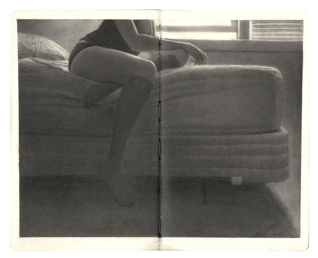 In a grayscale image evoking graphite art by Zachary Oldenkamp, a person sits on a beds edge in a softly lit room. Wearing a dark top and socks with one leg bent, light filters through blinds casting gentle shadows—a scene ideal for custom framing.
